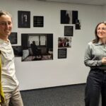 Zwei Frauen, im Hintergrund hängen Fotografieren an einer Wand